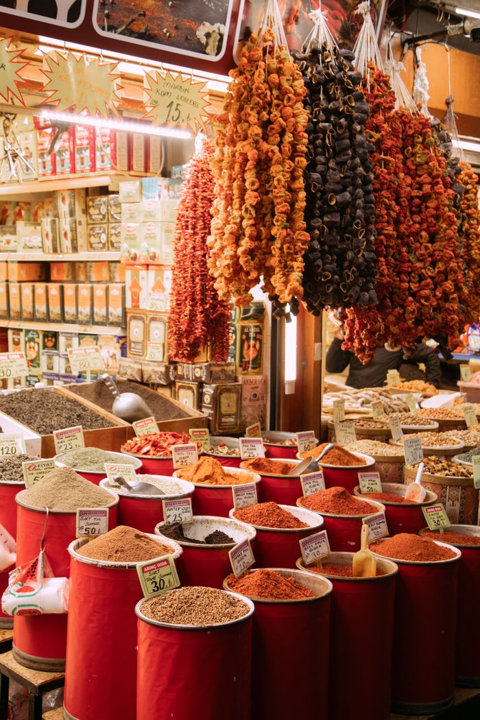 Colorful spice market scene in Istanbul, showcasing local herbs and dried goods.